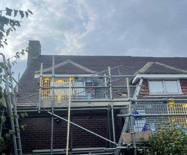 This is a photo of a roof with two dormers that is having some damaged tiles replaced. Works carried out by KAM Roofing Askern